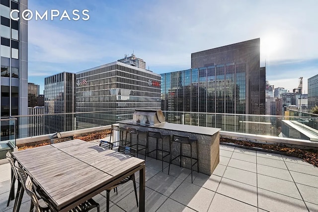 135 W 52nd St Unit 40A, New York City, NY 10019 - view of patio / terrace with a city view and area for grilling