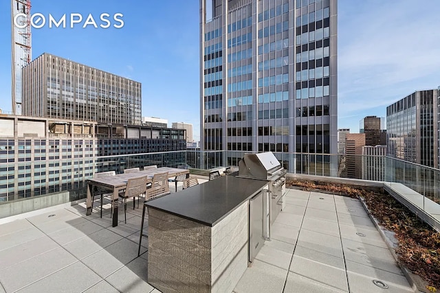 135 W 52nd St Unit 40A, New York City, NY 10019 - view of patio with exterior kitchen, a city view, and outdoor dining area