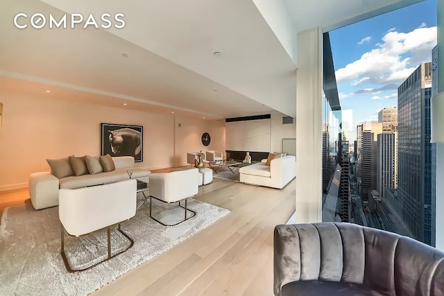 135 W 52nd St Unit 40A, New York City, NY 10019 - living area featuring wood finished floors and floor to ceiling windows