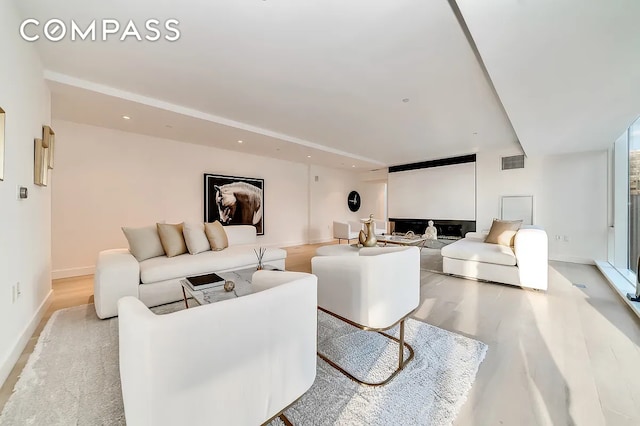 135 W 52nd St Unit 40A, New York City, NY 10019 - living area featuring wood finished floors and recessed lighting