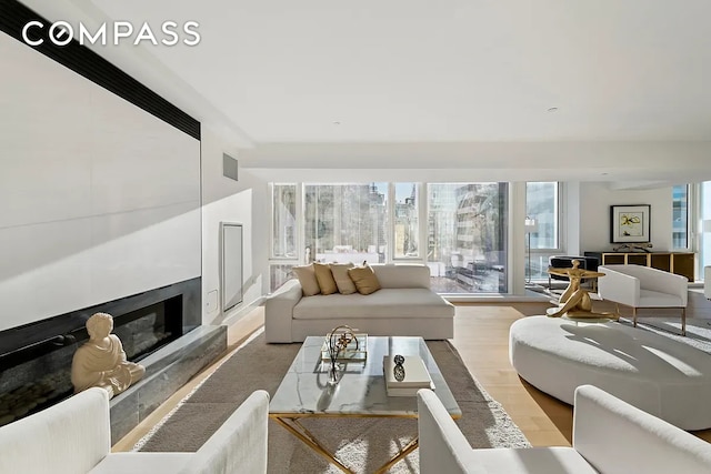 135 W 52nd St Unit 40A, New York City, NY 10019 - living room featuring a fireplace and wood finished floors