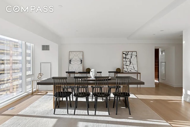 135 W 52nd St Unit 40A, New York City, NY 10019 - dining space with wood finished floors and baseboards