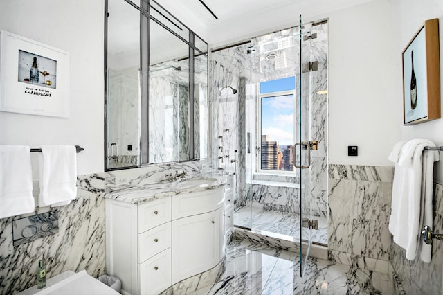 full bath featuring marble finish floor, tile walls, a wainscoted wall, vanity, and a marble finish shower