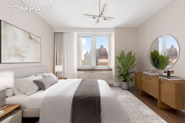 bedroom featuring a skyline view and wood finished floors