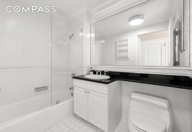 full bath with crown molding, toilet, shower / washtub combination, a towel warming rack, and vanity
