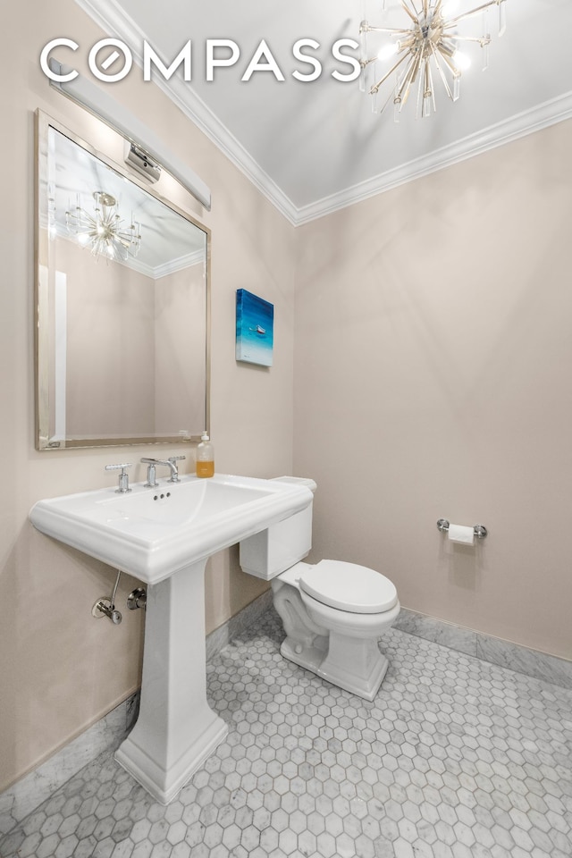 bathroom with a chandelier, crown molding, baseboards, toilet, and tile patterned floors