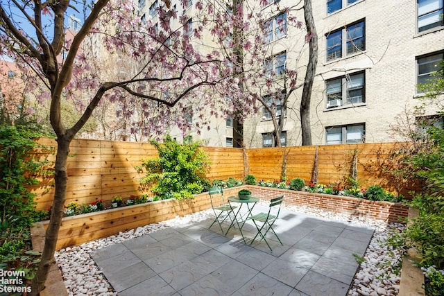 view of patio with a fenced backyard and outdoor dining space