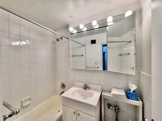 148 E 84th St Unit 2A, New York City, NY 10028 - full bathroom featuring bathtub / shower combination, tile walls, vanity, and backsplash