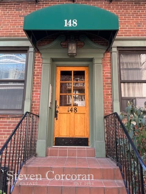 148 E 84th St Unit 2A, New York City, NY 10028 - property entrance featuring brick siding