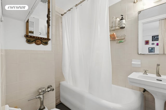 45 Tudor City Pl Unit 808, New York City, NY 10017 - full bath featuring tile walls, shower / bath combination with curtain, and a sink