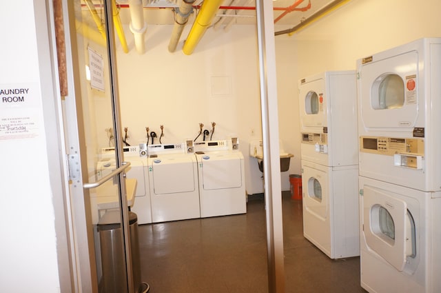 shared laundry area featuring stacked washer / dryer and washing machine and clothes dryer