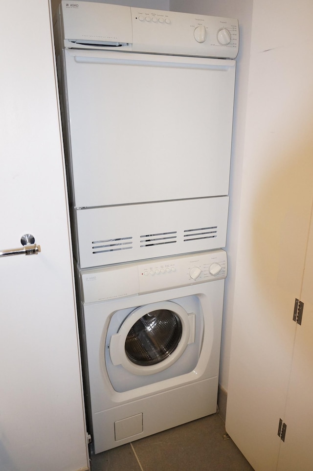 washroom with stacked washer / dryer and laundry area