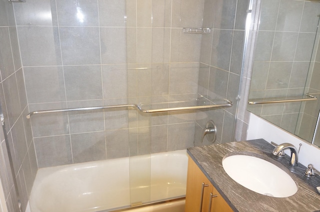 full bathroom with combined bath / shower with glass door and vanity