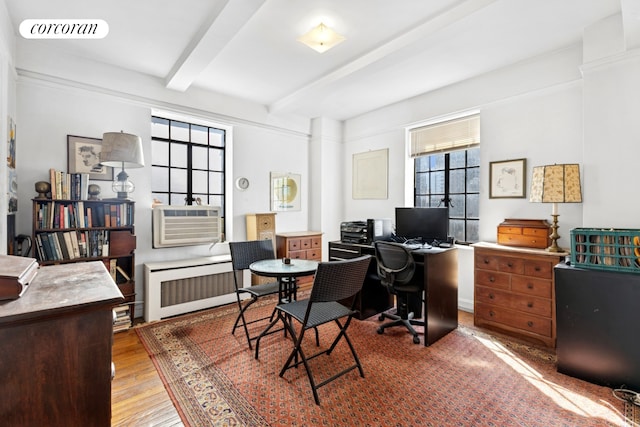 25 Tudor City Pl Unit 1812, New York City, NY 10017 - office area featuring radiator heating unit, beamed ceiling, cooling unit, and wood finished floors