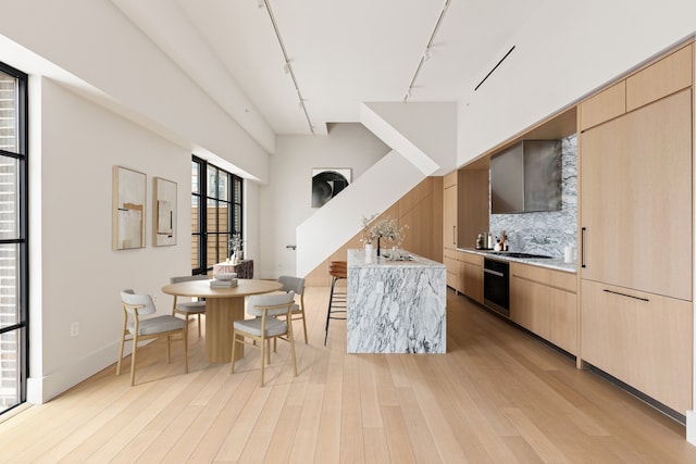 517 W 29th St Phc, Phc, New York City, NY 10001 - kitchen featuring track lighting, light brown cabinetry, modern cabinets, and light wood-type flooring