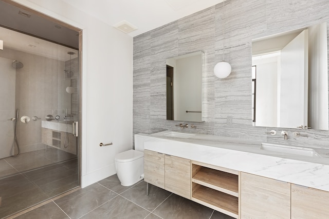 517 W 29th St Phc, Phc, New York City, NY 10001 - bathroom with a tile shower, double vanity, and tile walls
