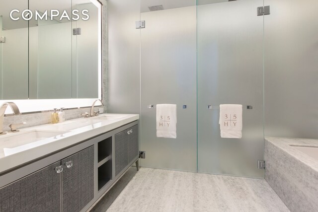 35 Hudson Yards Unit 5805, New York City, NY 10001 - full bath with double vanity, an enclosed shower, and wood finished floors