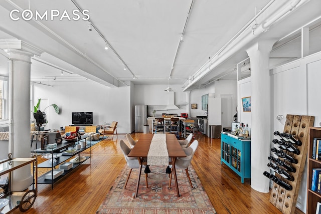565 Broadway Unit 8W, New York City, NY 10012 - dining area featuring track lighting, hardwood / wood-style floors, and decorative columns