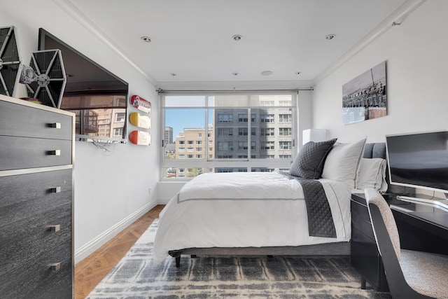 bedroom with baseboards and ornamental molding