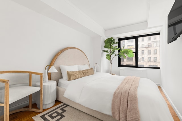 220 E 57th St Unit 17E, New York City, NY 10022 - bedroom featuring baseboards and wood finished floors