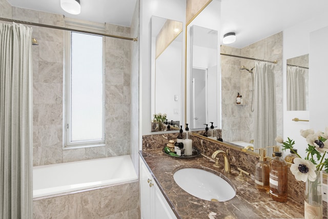 full bath with tiled shower / bath combo and vanity