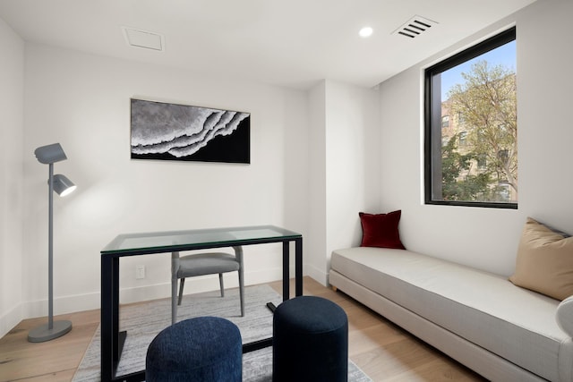 living area with baseboards, recessed lighting, wood finished floors, and visible vents