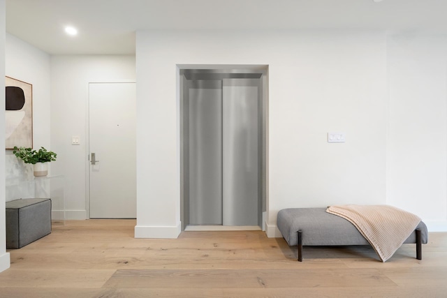 interior space featuring recessed lighting, baseboards, and light wood-style flooring