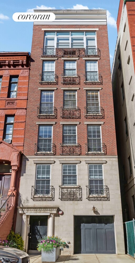 203 W 122nd St Unit 4, New York City, NY 10027 - view of apartment building / complex featuring a garage and driveway