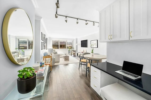 interior space with rail lighting and dark wood-type flooring