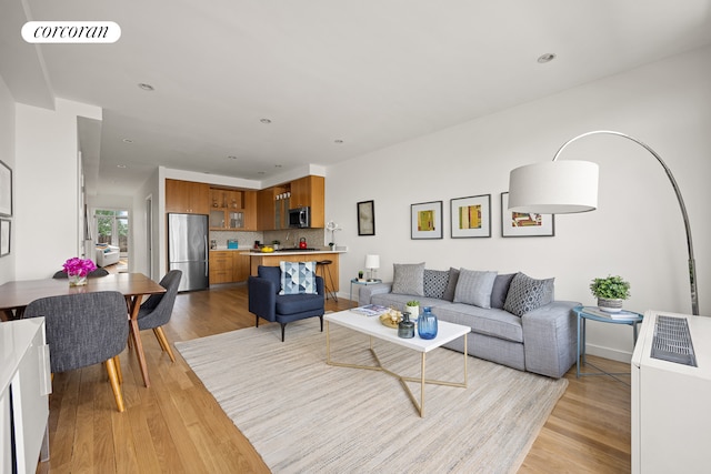 living room featuring visible vents, recessed lighting, and light wood finished floors