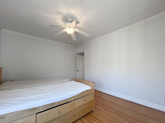 bedroom with baseboards, ornamental molding, light wood finished floors, and ceiling fan