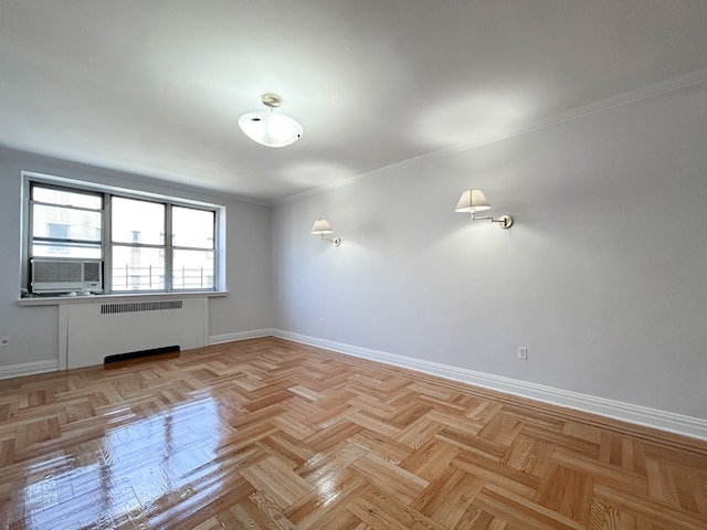 spare room featuring radiator heating unit, baseboards, crown molding, and cooling unit