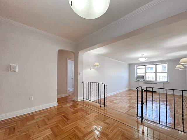 spare room featuring baseboards, arched walkways, crown molding, and cooling unit