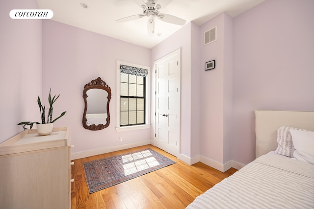 bedroom with visible vents, baseboards, ceiling fan, and light wood-type flooring