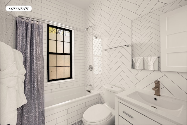 bathroom featuring vanity, tiled shower / bath combo, toilet, and tile walls