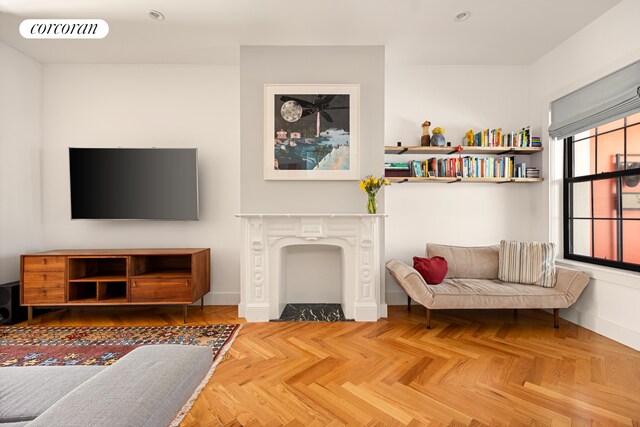 living area featuring baseboards and a fireplace