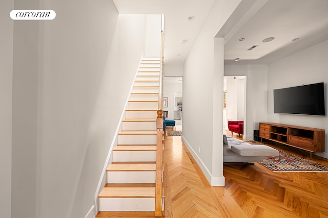 stairs with baseboards and visible vents