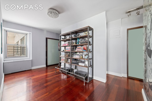 miscellaneous room featuring baseboards and wood finished floors