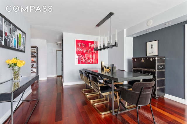 dining area with baseboards and hardwood / wood-style floors