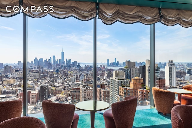 dining room with a view of city, floor to ceiling windows, and a healthy amount of sunlight