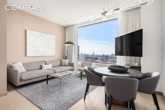 living room with expansive windows and wood finished floors