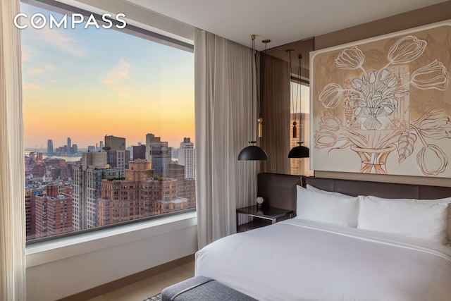 bedroom with a view of city