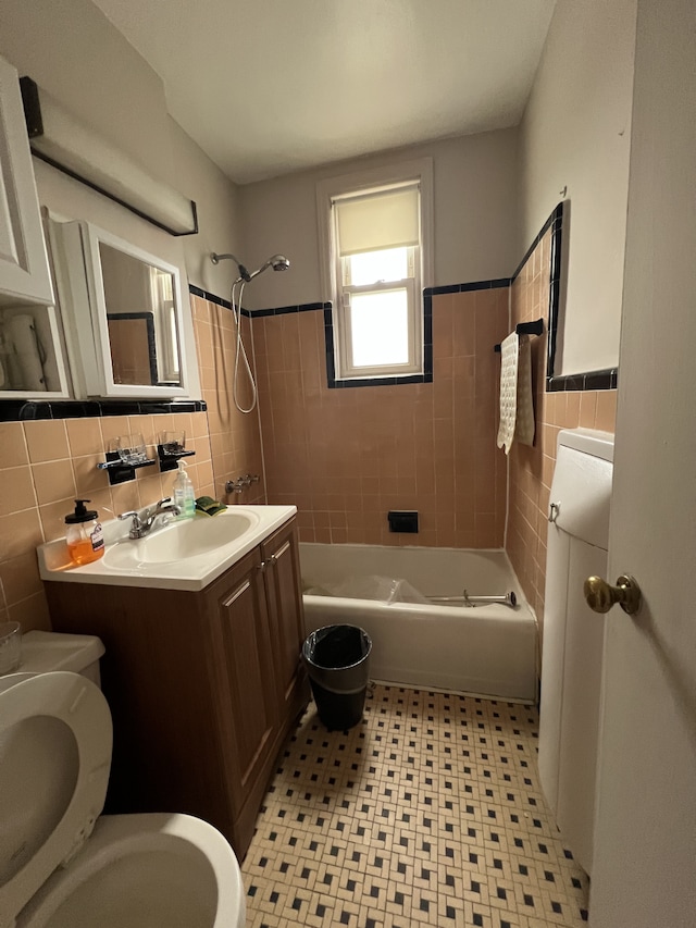 1774 E 54th St Unit 13B, New York City, NY 11234 - bathroom with toilet, tile walls, vanity, washtub / shower combination, and tile patterned floors