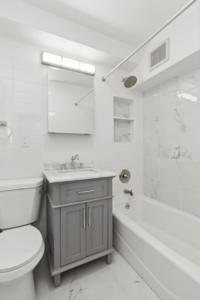full bath with visible vents, marble finish floor, toilet, vanity, and bathtub / shower combination