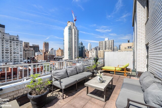 view of patio featuring an outdoor living space and a city view