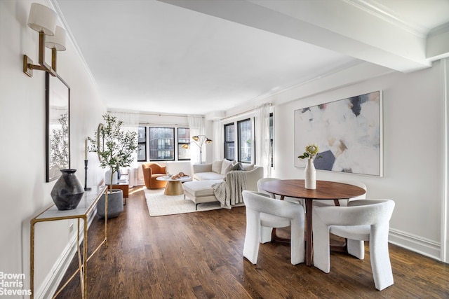 dining space with ornamental molding and dark wood-style flooring