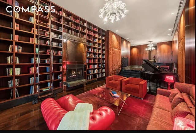 interior space featuring wooden walls, a notable chandelier, and wood finished floors