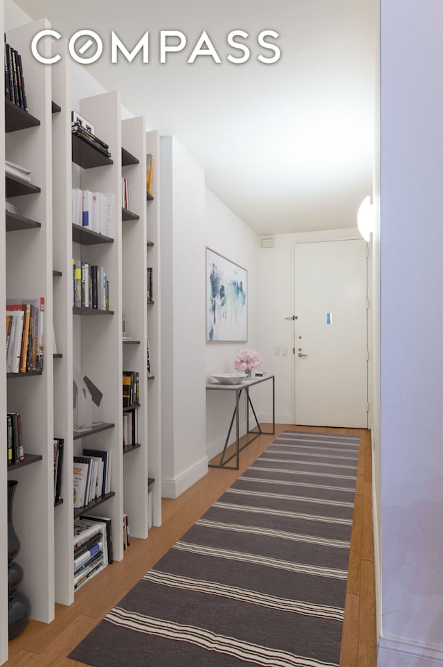 corridor with light wood-style flooring