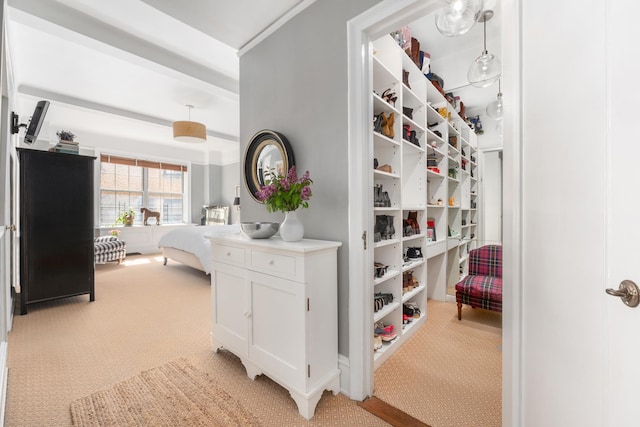 hall featuring light colored carpet