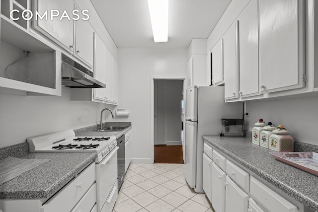 kitchen featuring white appliances, white cabinetry, under cabinet range hood, a sink, and light tile patterned floors